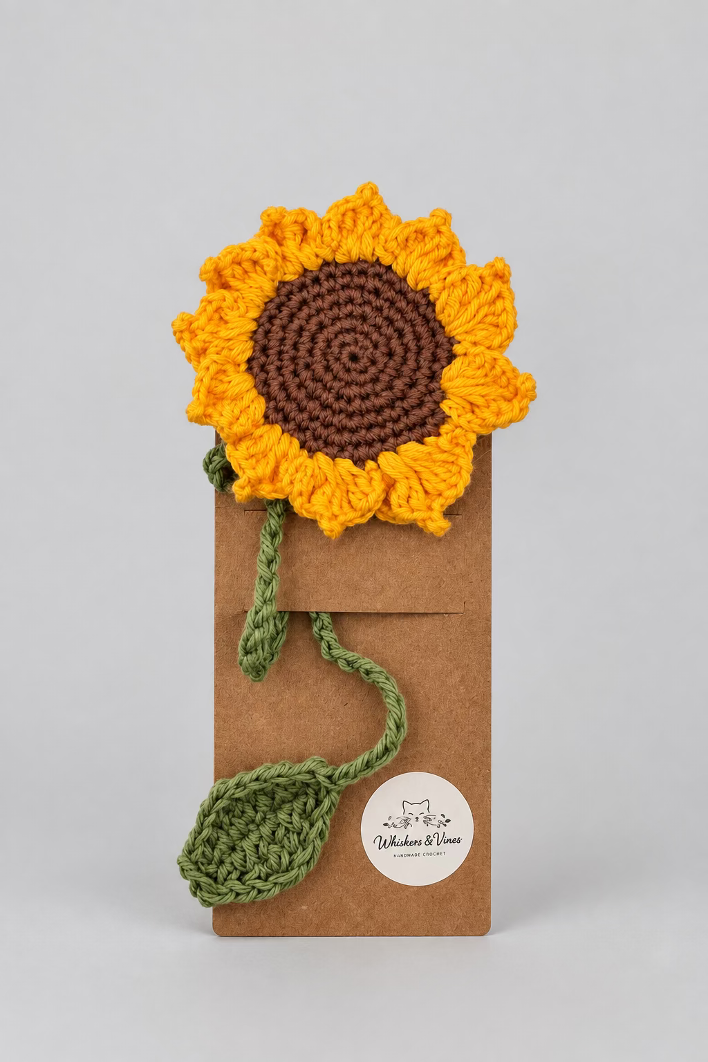 Crocheted sunflower with a brown center on a white background