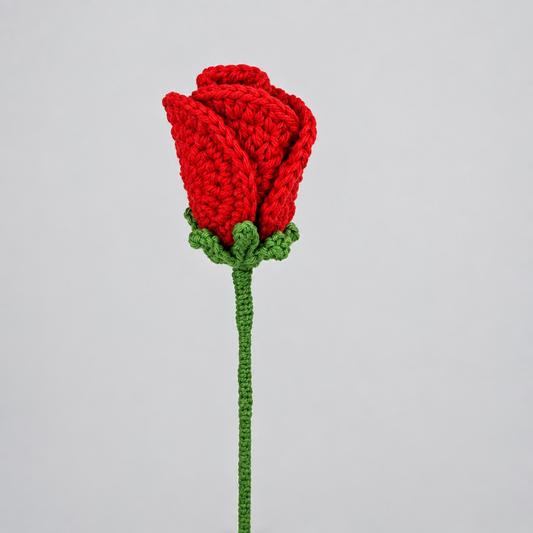 Crocheted red rose on a white background